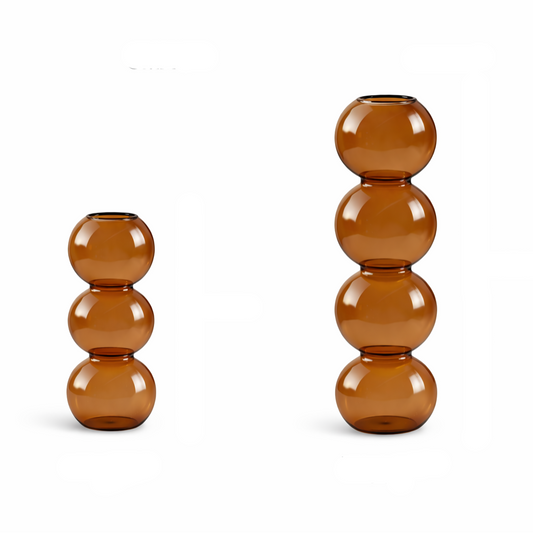 Set of two brown glass candle holders on a white background