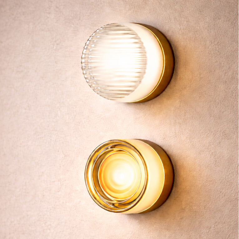Two round wall lights on a beige wall